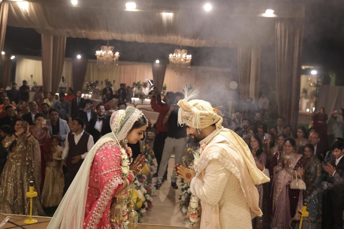 Bride and groom sharing a respectful moment after the varmala ceremony.