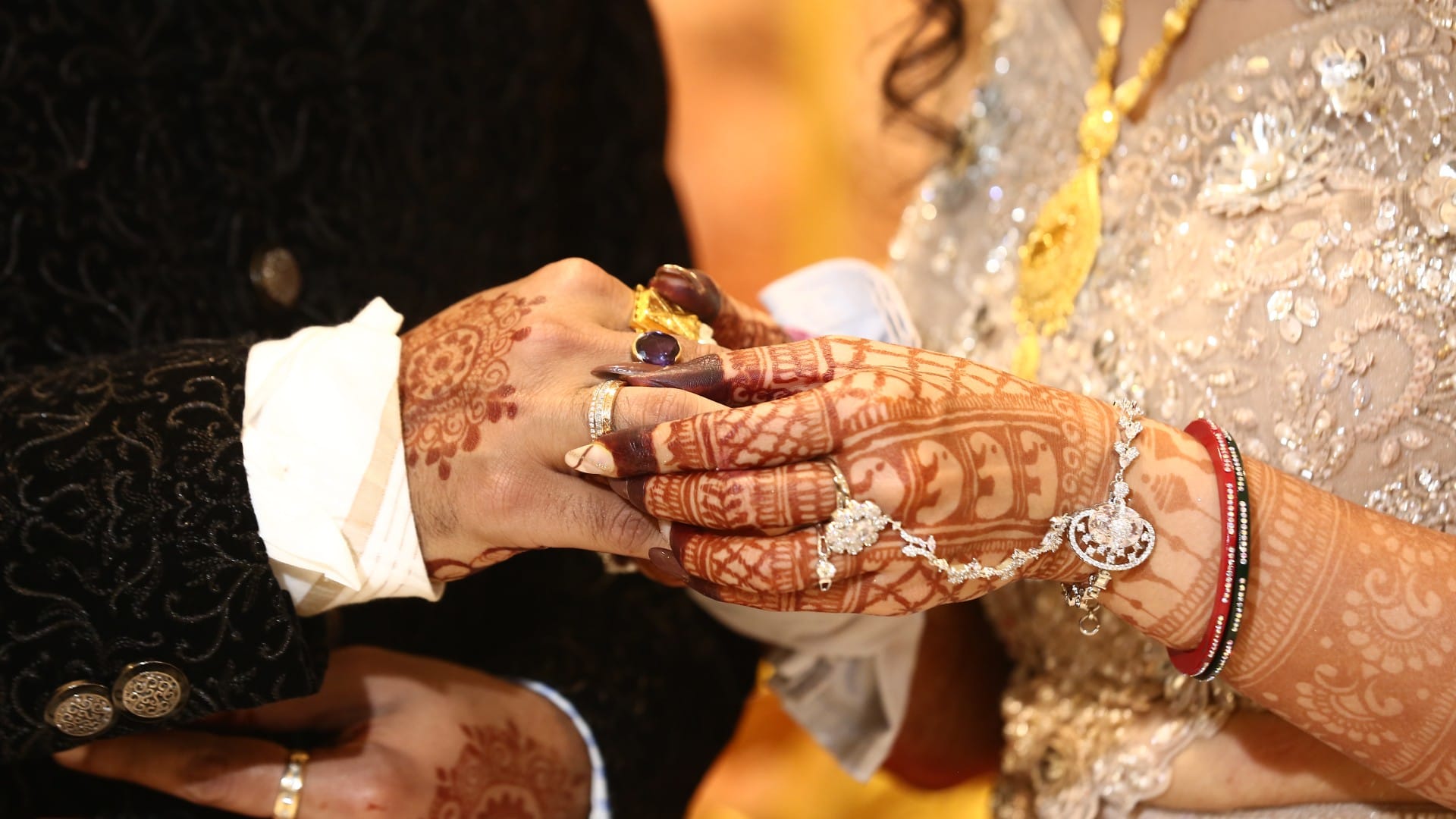 Close-up of the engagement ring exchange between the couple.